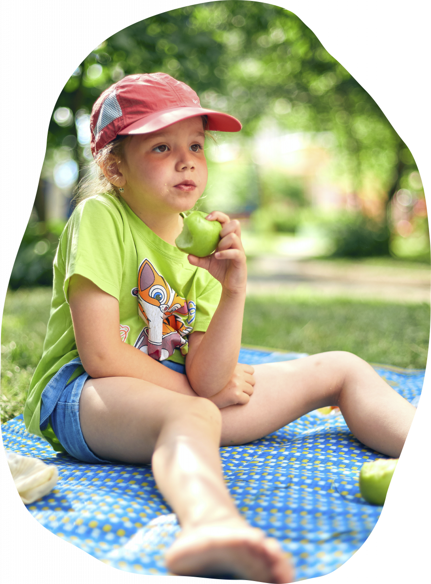 Girl eating an apple in the park
